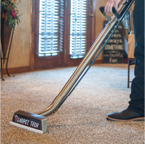 Carpet Tech technician cleaning carpet in a home