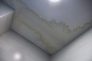 Water stain on the home ceiling. Concept of condensation, damp, water infiltration, high humidity and respiratory problems.
