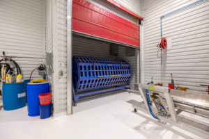 Industrial facility with blue drum machine and conveyor